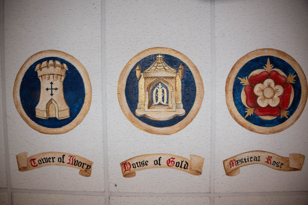 Chaplaincy ceiling, with iconic emblems painted on ceiling and scroll motto statements underneath icons.